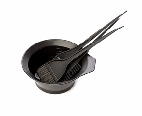 bowl and black plastic brushes for hair coloring isolated on white background