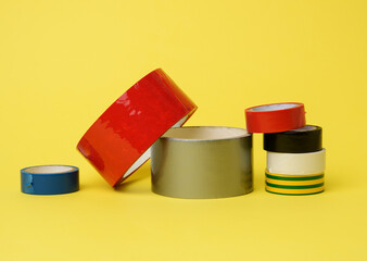 various skeins of multicolored scotch tape and electrical tape