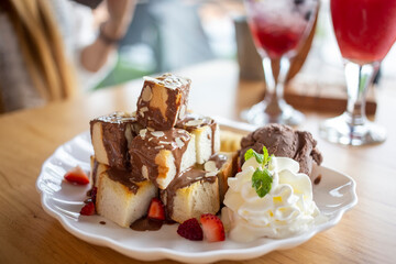 Toast with chocolate ice cream on a white plate in the cafe.