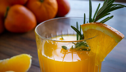 Food background. Orange, tangerine, persimmon and orange juice glass on the wooden table