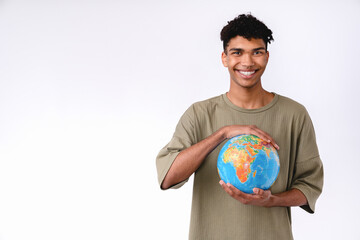 Smiling young african man holding a globe with love isolated over white background