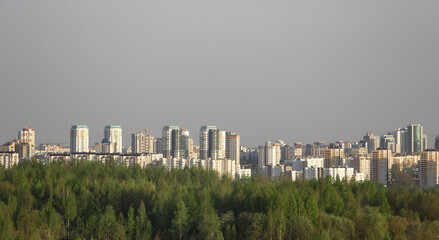 City behind the forest, in autumn