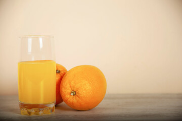 orange and natural orange juice on a white table background