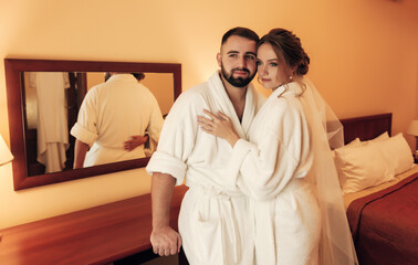
lovers in the bedroom in bathrobes