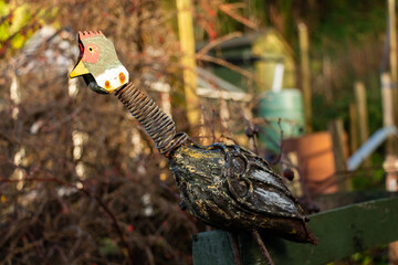 Rusty cockerel garden ornament in the winter sun