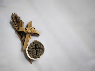Lent Season,Holy Week and Good Friday Concepts - photo of bowl of ash with cross made of palm leave...