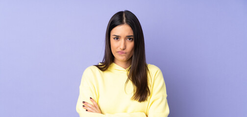 Young caucasian woman over isolated background with unhappy expression