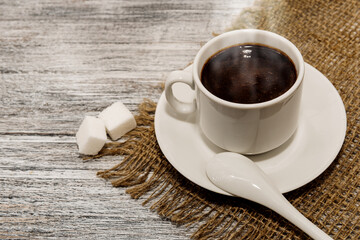 A cup of ground coffee. A cup of coffee on a gray wooden background. A tonic and invigorating drink...