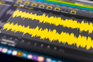 macro view of the computer monitor screen with sound audio wave graph volume