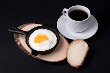 fried eggs for breakfast in a cast-iron frying pan