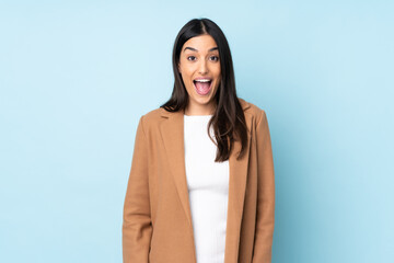 Young caucasian woman isolated on blue background with surprise facial expression