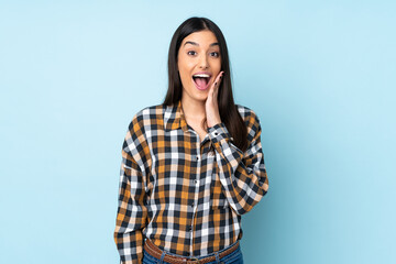 Young caucasian woman isolated on blue background with surprise and shocked facial expression