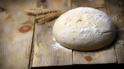 Selective focus. Yeast dough for baking bread and ears of wheat. Homemade bread making.