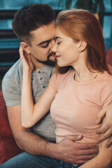 Ginger woman with freckles is embracing her lover while dating the valentines day together