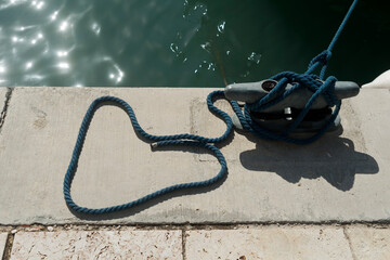 Heart shaped mooring rope on sea pier 