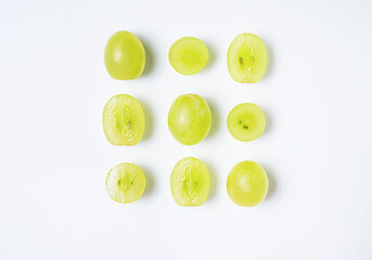 Creative flat lay made of  green grapes  on white background. Top view and copy space