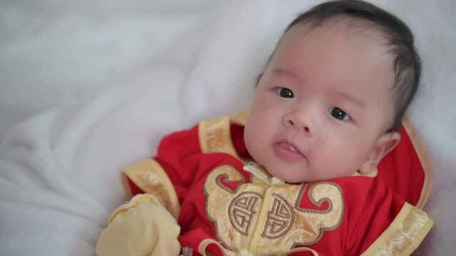 baby boy dressing Chinese red suit, kid wear qipao for chinese new year day.