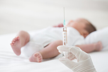 Syringe with blur baby background. Vaccine antivirus for infant .concept
