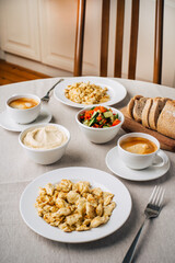 Breakfast. Scrambled eggs or omelet, hummus, coffee, vegetable salad, bread. Dinner table