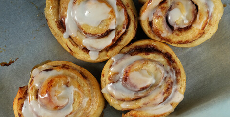 Sweet breakfast food shows cinnamon rolls as pastry from top view.