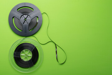 on a green background, two retro magnetic coils for listening to music, on the right there is a...