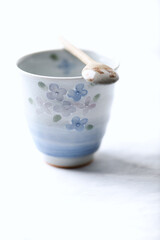 Traditional, handcrafted ceramic on bright wooden background. Soft focus. Close up.