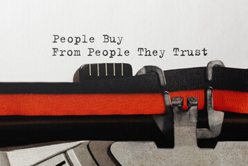 Text People Buy From People They Trust typed on retro typewriter