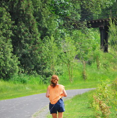 Female beauty jogging on a trail outside.