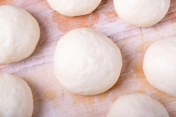 Yeast dough balls on the wooden board