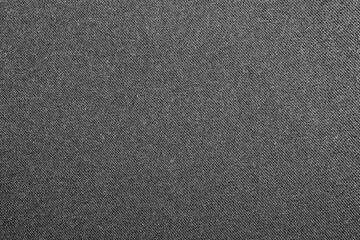 Dark gray denim background.The texture of black fluted denim.Background of black jeans.