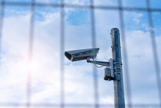 Street Security Camera Next To Iron Fence, Border, Prison, Concept Picture