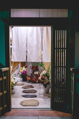 Traditional entrance at japanese tea house with stones and flowers, Kyoto, Japan