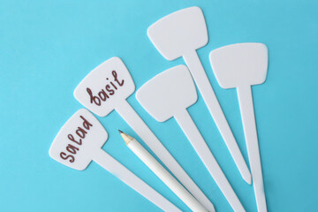 Pencil and white label for marking seedlings. Concept gardening, growing flowers and greenery.
