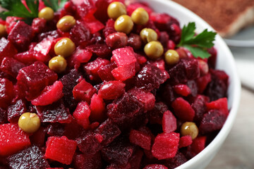 Traditional Russian salad vinaigrette in bowl, closeup