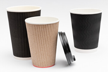 three empty cardboard cups for coffee on a white background