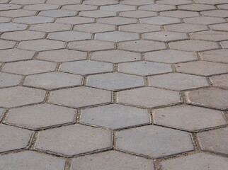the road is paved with hexagonal paving tiles.
