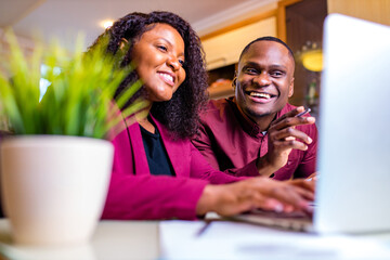 african american woman and man in home office in living room start up