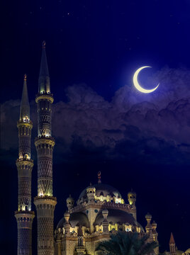  Al-Sahaba Mosque at night with a moon. Ancient mosque with two minarets in an old town of Sharm el Sheikh. Arabic architecture and monuments of Egypt in a moonlight.