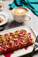 large waffles with filling on a gray background with coffee