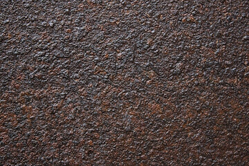 It's an old, rusty, dark-colored metal surface. Abstract background with texture on the corrosion of metals. Backdrop for the design