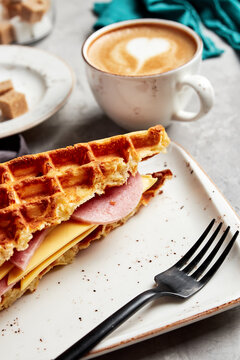 large waffles with filling on a gray background with coffee