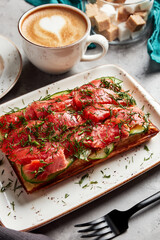 large waffles with filling on a gray background with coffee