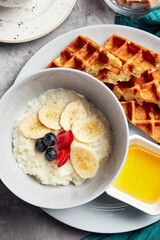 milk porridge with filling on a gray background with fruit tea