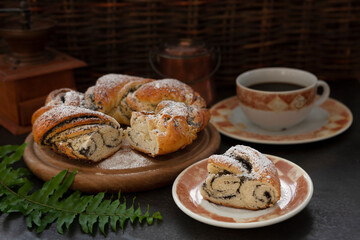 Close-up photo of homemade Pie with poppy seeds and a cup of black coffee.