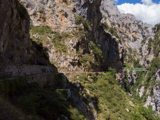 Fototapeta na wymiar The Los Rebecos (chamois) bridge at the Cares Route in the heart of Picos de Europa National Park, Cain-Poncebos, Asturias, Spain. This walkway comes from reservoir of Doiras.