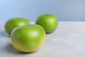 Fresh ripe sweeties on light grey table, space for text