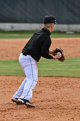 Action photo of high school baseball players making amazing plays during a baseball game
