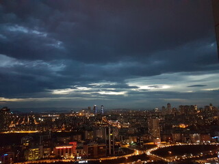 Fototapeta na wymiar Illuminated Cityscape Against Sky At Night