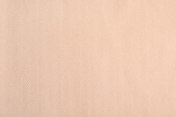 Beige soft cashmere fabric as background, closeup