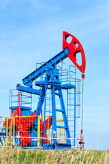 The blue and red oil rig on a sunny day against a blue sky. Front view.